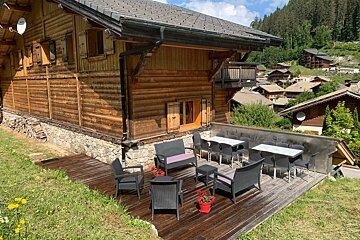 A wooden house with a satellite dish on top of it