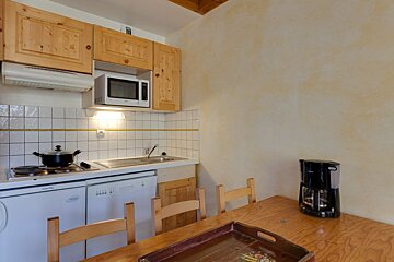 A kitchen with a microwave and a coffee maker