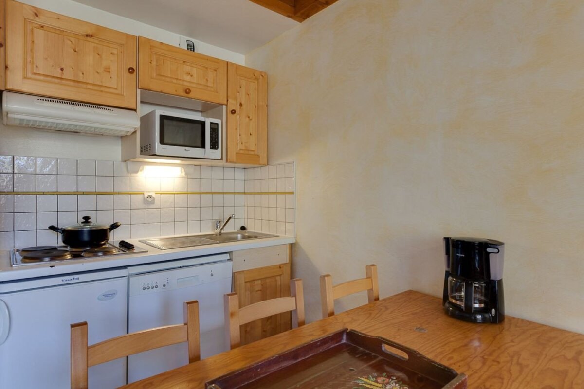 A kitchen with a microwave and a coffee maker