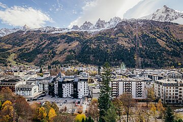 An aerial view of a city with mountains in the background