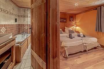 A bedroom with two beds and a bathtub in it