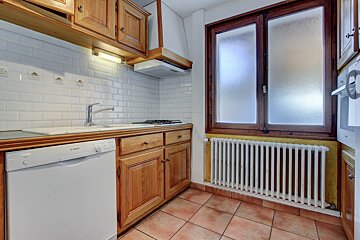 A bosch dishwasher sits in a kitchen next to a window