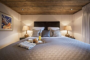 A bed with a newspaper on it that says the times