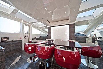 A dining room with red chairs and a table