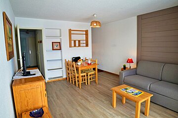 A living room with a couch a table and chairs