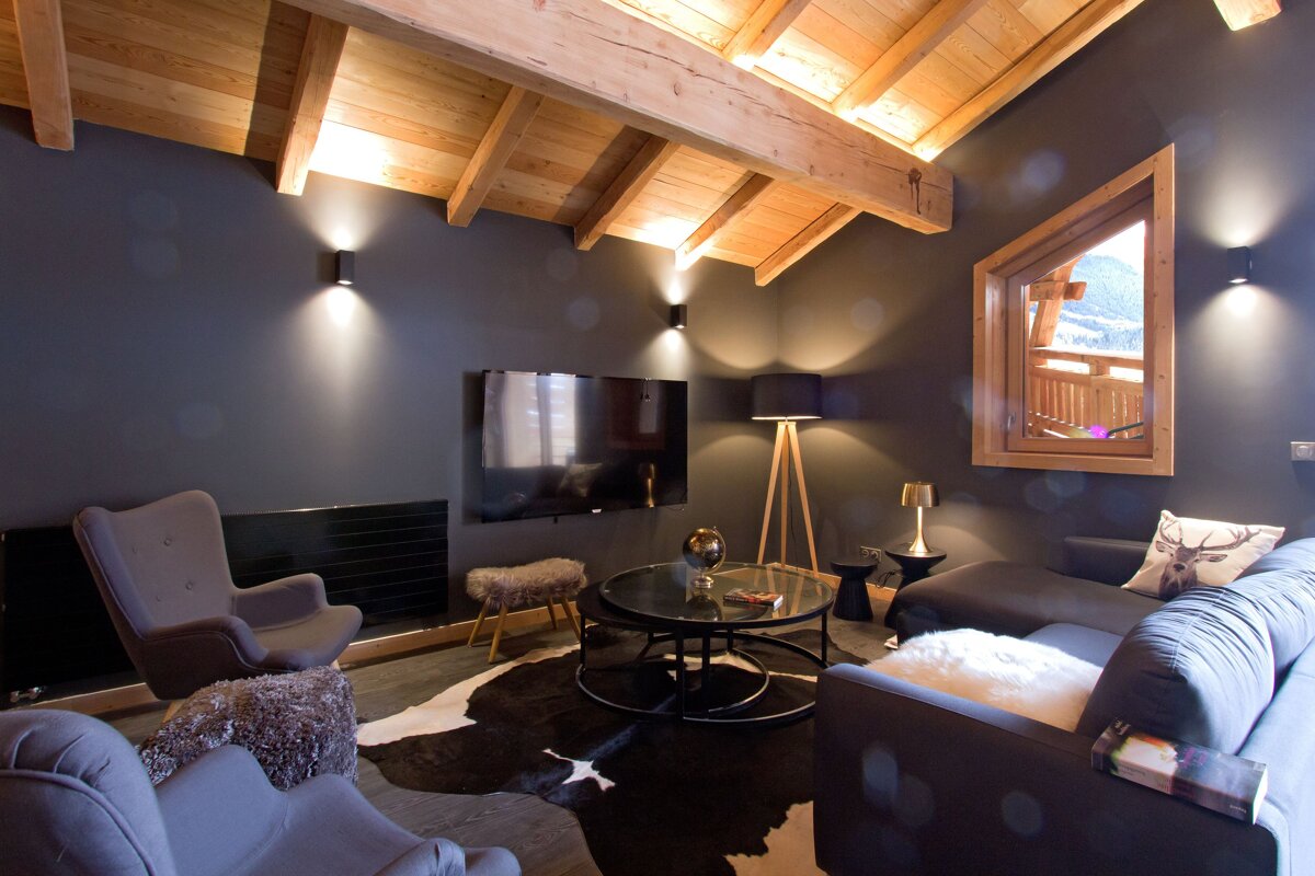 A living room with a couch a chair and a flat screen tv