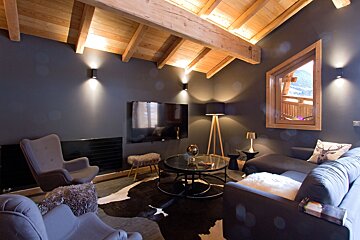 A living room with a couch a chair and a flat screen tv