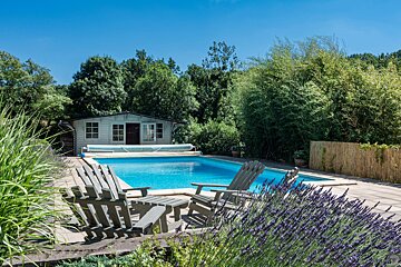 A swimming pool with a shed in the background