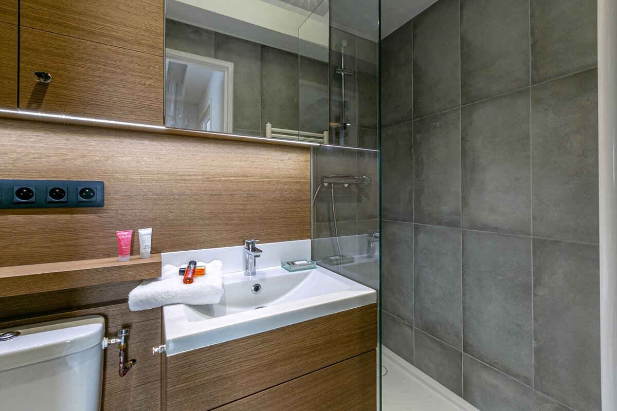 A bedroom with a large window and a bed