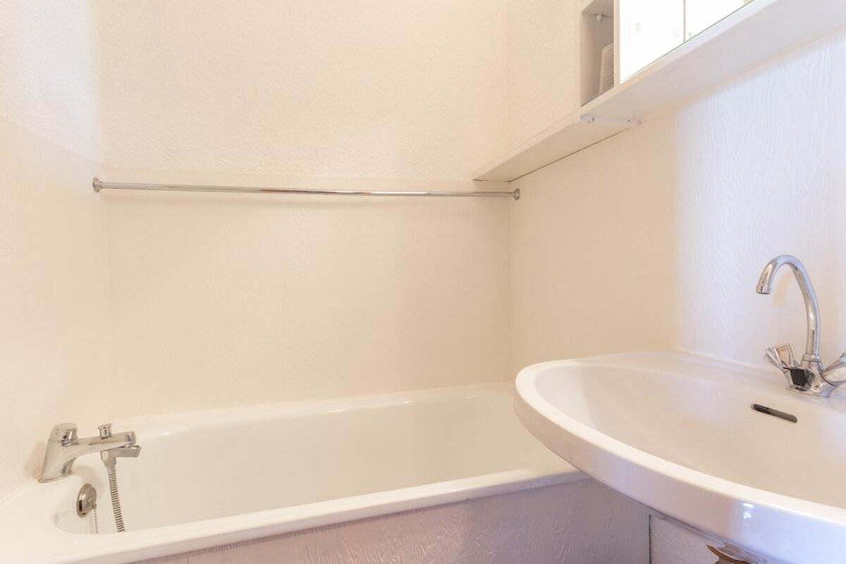 A bathroom with a bathtub and a sink