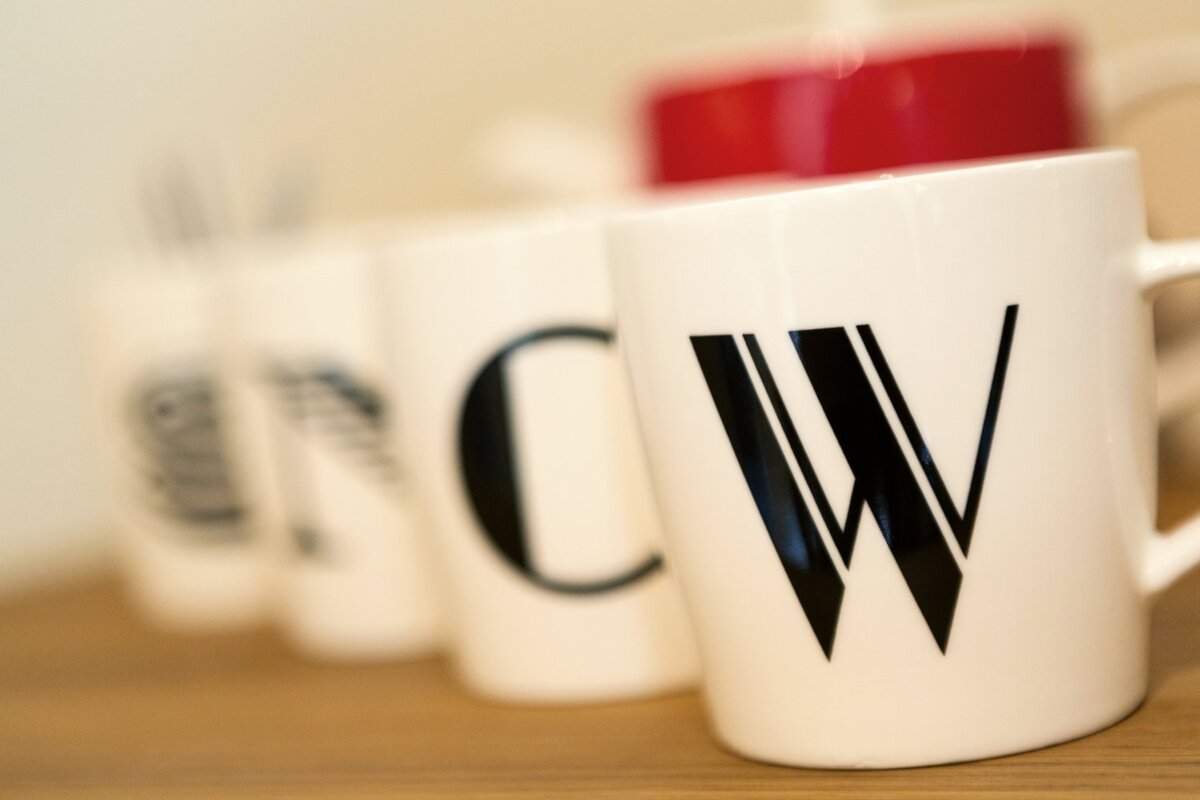 A white mug with the letter w on it