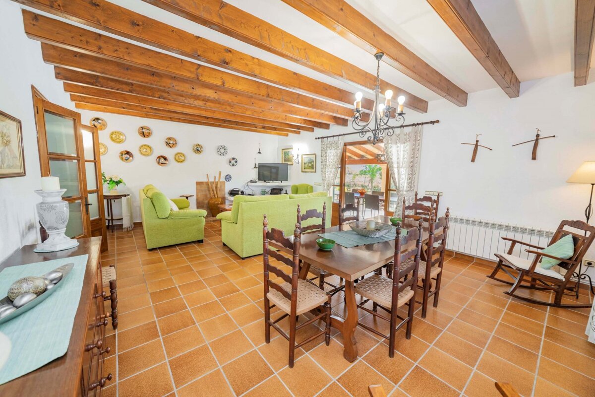 A living room with a dining table and chairs