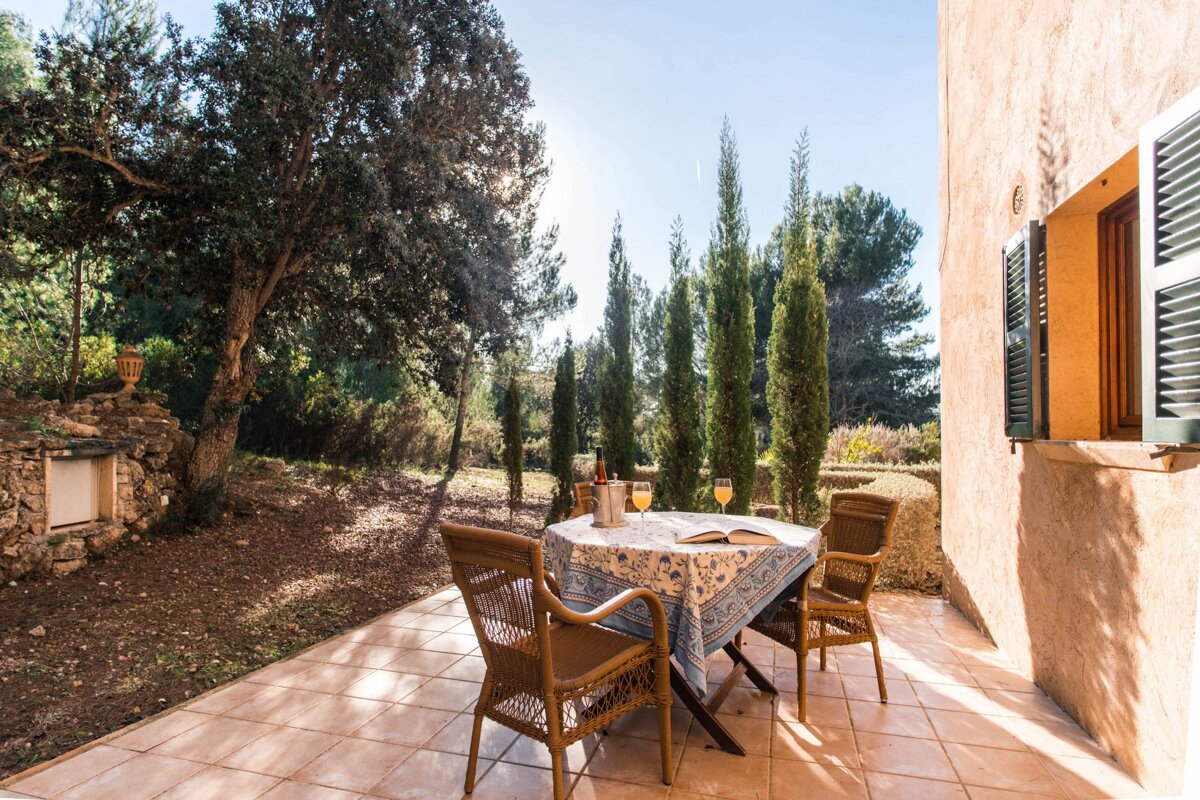 A patio with a table and chairs and a book on it