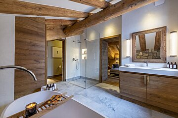 A bathroom with a bathtub a sink and a mirror