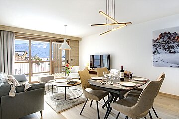 A living room with a dining table and chairs