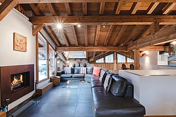 A living room with a couch and a fireplace
