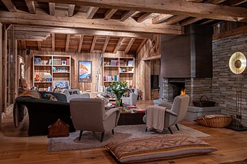 A living room with a fireplace and bookshelves