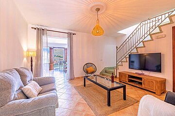 A living room with a couch and a flat screen tv