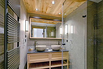 A bathroom with two sinks and a large mirror