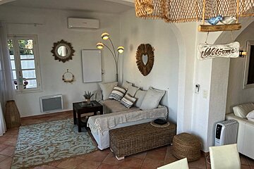 A living room with a welcome sign hanging on the wall