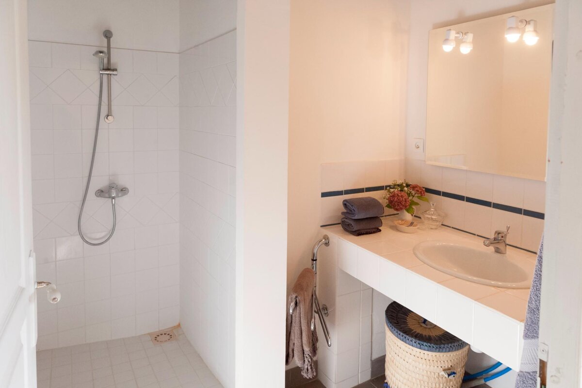 A bathroom with a sink and a walk in shower