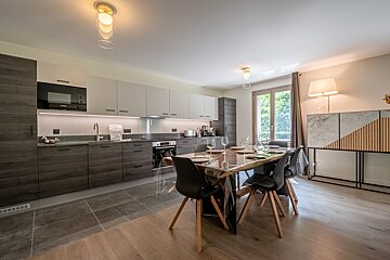 A kitchen with a table and chairs in it
