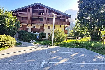 A building with a parking lot in front of it