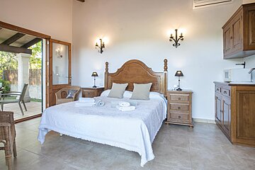 A bedroom with a large bed and two nightstands