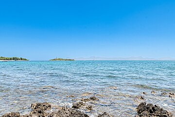 A large body of water with a small island in the distance