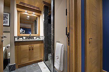 A bathroom with wooden cabinets and a mirror