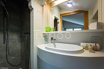 A bathroom with a sink and a mirror with the word tengo on it