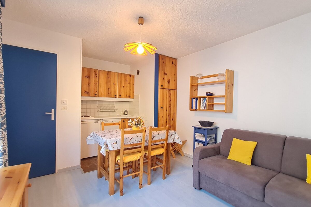 A living room with a table and chairs and a couch