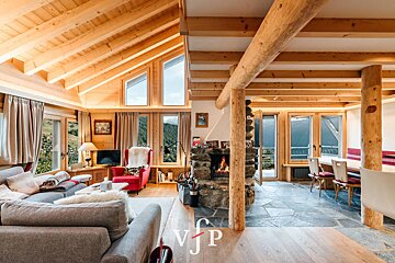 A living room with a fireplace and a vjp logo