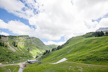 A ski lift is going up a hill in the mountains