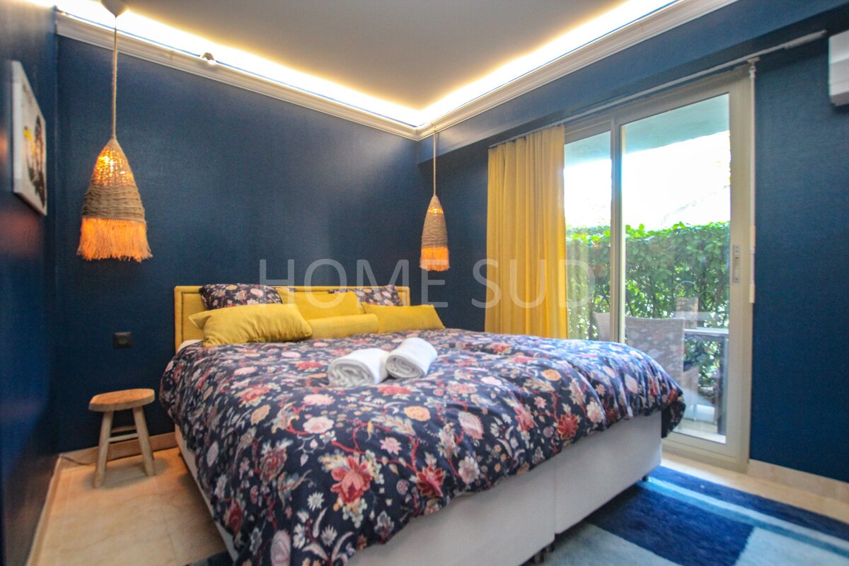 A bedroom with blue walls and a bed that says home suite