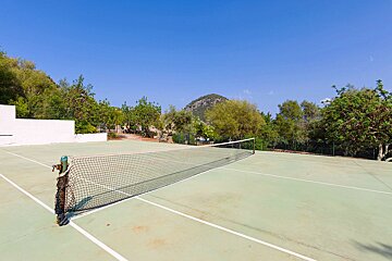 A tennis court with a mountain in the background