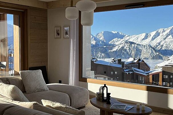 A living room with a view of snowy mountains