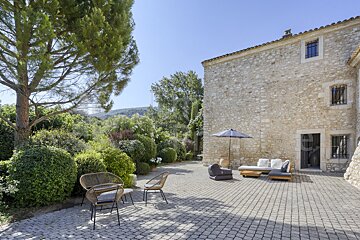 A stone building with a patio area in front of it