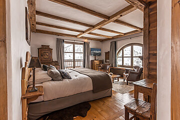 A bedroom with a large bed and a large window