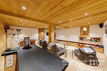 A rugby ball sits on a counter in a living room with a sign that says mountain base
