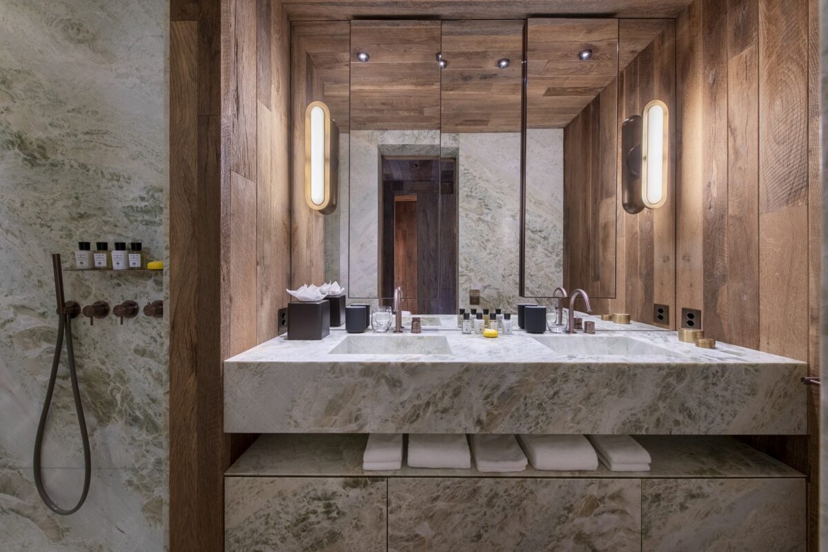 A bathroom with two sinks and a large mirror
