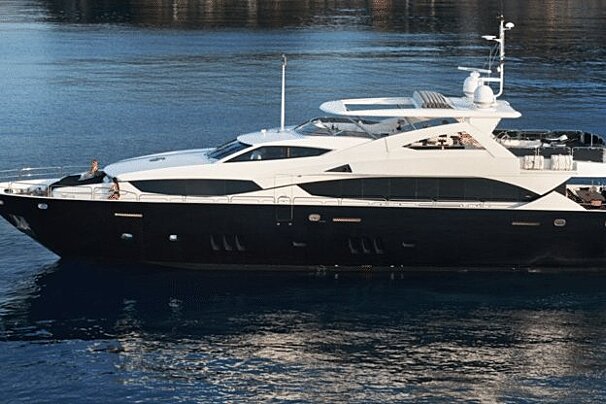 A large black and white yacht is floating in the water