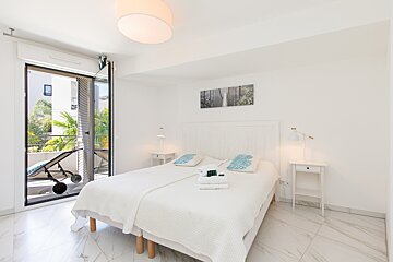 A bedroom with a large bed and two nightstands