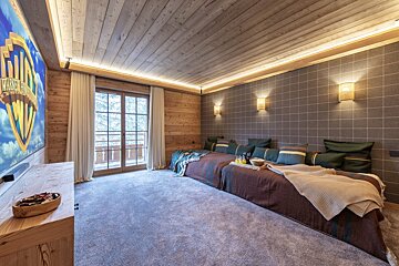 A room with a couch and a screen that says ' warner bros ' on it