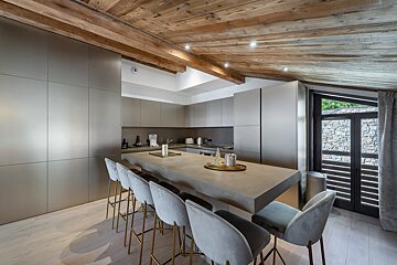 A kitchen with a large island and stools