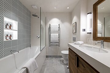 A bathroom with a bathtub toilet and sink