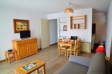 A living room with a couch a table and a television
