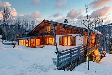 A snowy house with a sign that says ' a ' on it