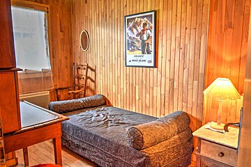 A bedroom with a poster on the wall that says france mont blanc