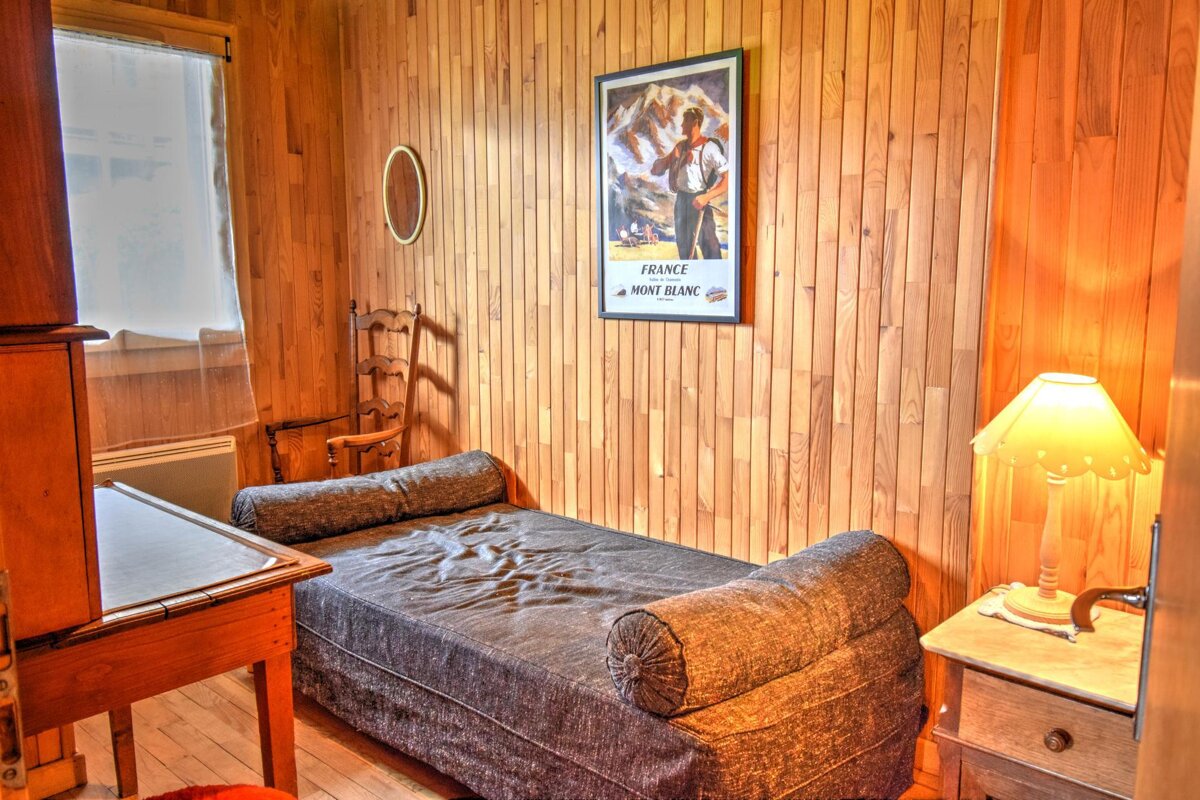 A bedroom with a poster on the wall that says france mont blanc